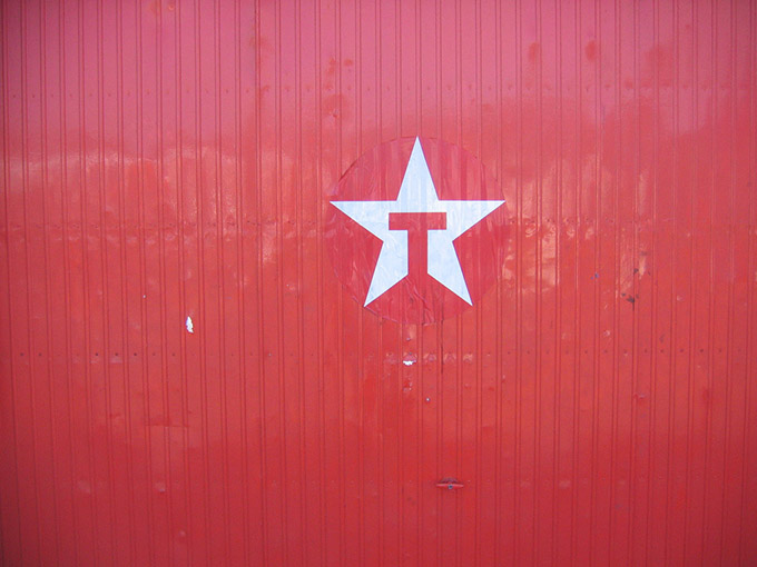 White star and red letter T on a red wall