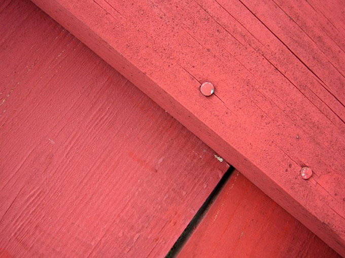 Close up of red nailed wood