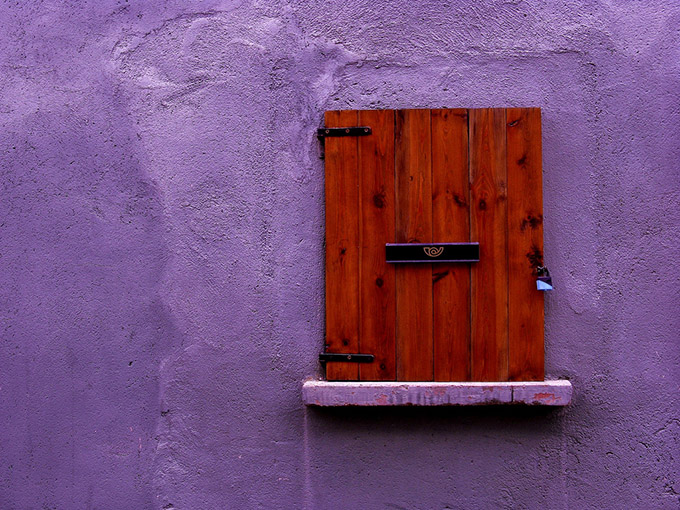Purple wall with red locked window/door